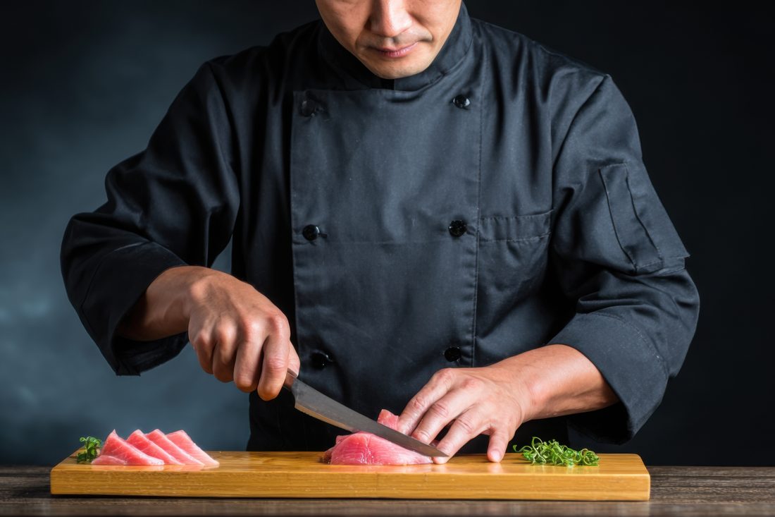 Sushikoch schneidet Sashimi
